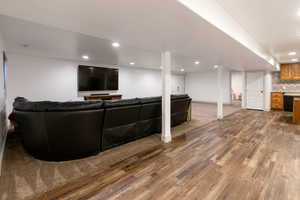 Living room with dark wood finished floors and recessed lighting