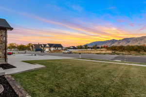 Yard at dusk with a yard and a mountain view