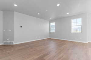 Unfurnished room with recessed lighting and light wood-type flooring