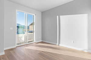 Unfurnished room with baseboards and light wood-style floors