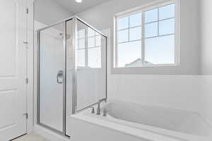 Full bath with a shower stall and a garden tub