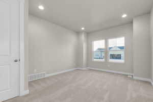 Unfurnished room featuring light carpet and recessed lighting
