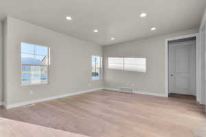 Empty room featuring recessed lighting and light wood-style floors