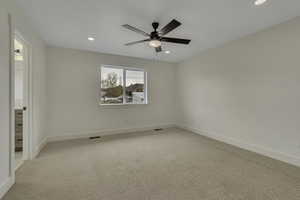 Empty room featuring carpet, recessed lighting, and ceiling fan