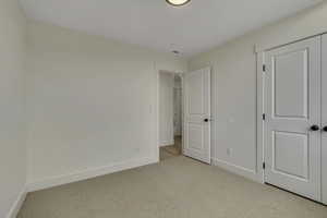 Unfurnished bedroom featuring carpet floors and a closet