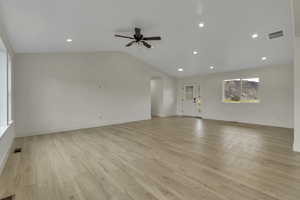 Unfurnished living room featuring light wood-style floors, recessed lighting, vaulted ceiling, and a ceiling fan