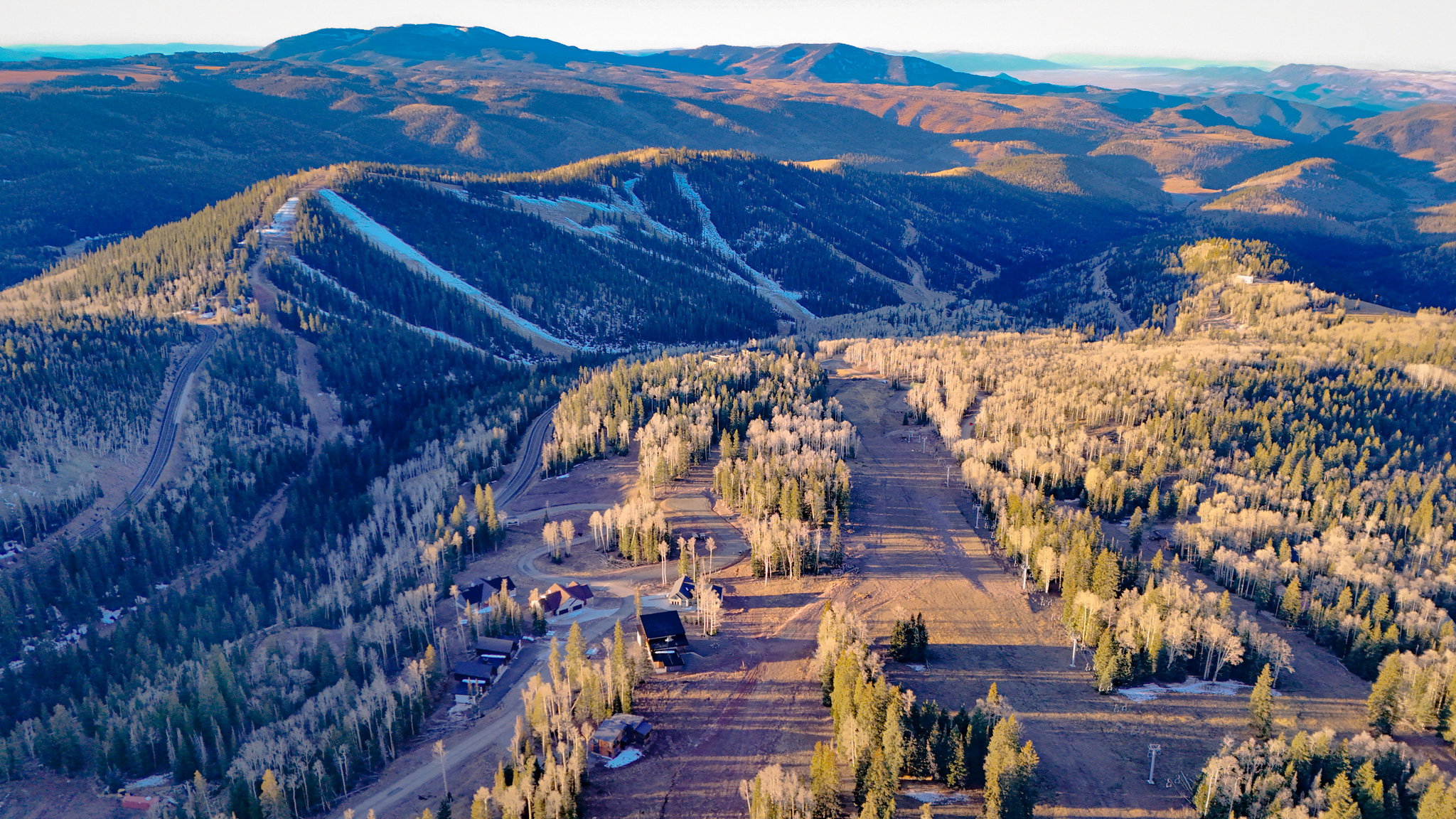 View of mountain backdrop featuring a forest