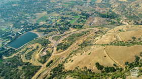 Aerial view of property's location featuring a large body of water
