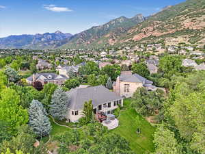 Aerial overview of property's location featuring the spacious yard and a mountain backdrop