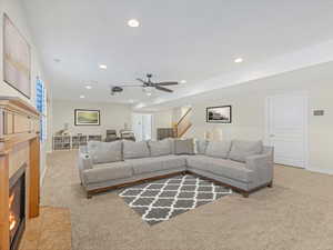 Family room with light carpet, recessed lighting, a fireplace, and a ceiling fan