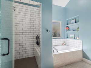 Full bathroom with a garden tub, a stall shower, built in features, and tile floors