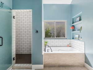 Bathroom featuring a garden tub and shower