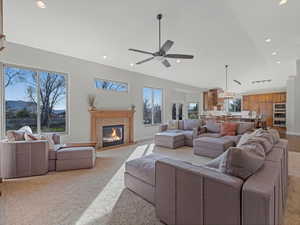 Carpeted family room with a fireplace, recessed lighting, and a ceiling fan