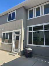 Property entrance featuring stucco siding