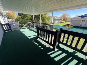 View of patio / terrace featuring a storage unit and a pool
