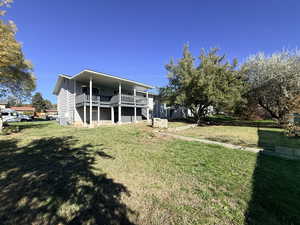 Back of house featuring a yard