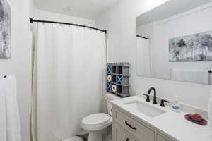 Full bathroom featuring vanity and a shower with shower curtain