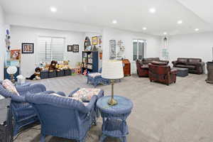 Carpeted living area with recessed lighting
