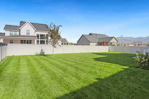 Fenced backyard featuring a mountain view