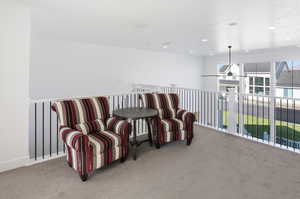 Living area with carpet and recessed lighting