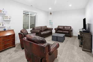 Living room with light carpet and recessed lighting