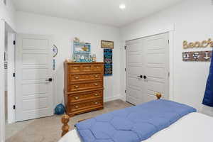 Bedroom featuring light carpet, a closet, and recessed lighting