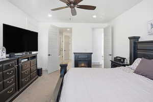 Bedroom featuring light colored carpet, recessed lighting, and ceiling fan