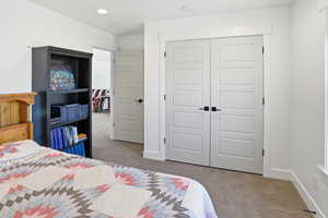 Bedroom featuring light carpet, a closet, and recessed lighting