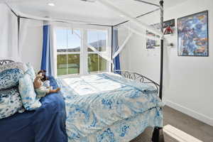 Bedroom with baseboards and light carpet flooring