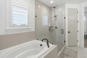 Full bath with a bath, light tile patterned floors, a shower stall, and recessed lighting