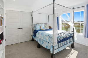 Bedroom with light carpet, a closet, and recessed lighting