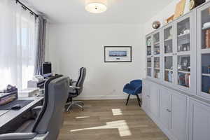 Home office featuring light wood-style floors and baseboards