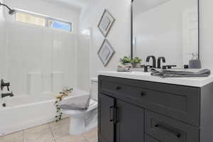 Bathroom with vanity, light tile patterned floors, and shower / bath combination