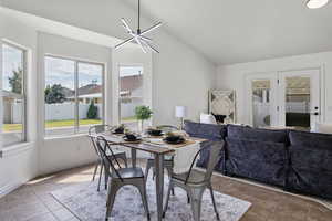 Dining space featuring vaulted ceiling and tile patterned floors