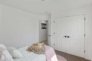 Bedroom with carpet floors and a closet
