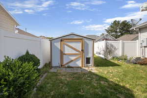View of shed featuring a fenced backyard