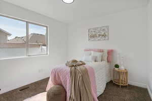 Bedroom with baseboards and carpet