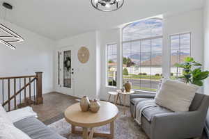Living area featuring a chandelier, a mountain view, and tile patterned flooring