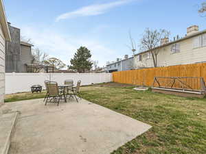 Fenced backyard featuring a patio and outdoor dining space