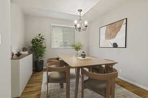 Dining area featuring light wood-type flooring and a chandelier