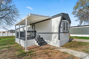 View of property exterior with a yard