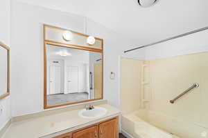 Bathroom with bathing tub / shower combination and vanity