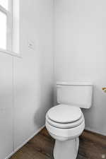 Bathroom featuring dark wood-style floors and toilet