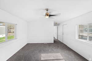 Unfurnished room featuring carpet flooring and ceiling fan