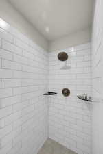 Full bath featuring tiled shower