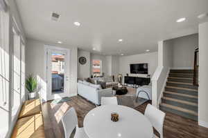 Dining room featuring stairs, recessed lighting, and wood finished floors