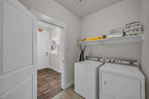 Laundry area with washing machine and dryer and baseboards