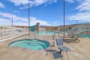 Community pool with a community hot tub and a patio