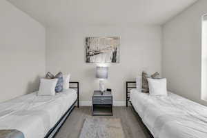 Bedroom featuring carpet flooring and baseboards