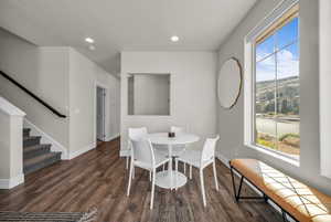 Dining room featuring stairs, recessed lighting, and dark wood-type flooring